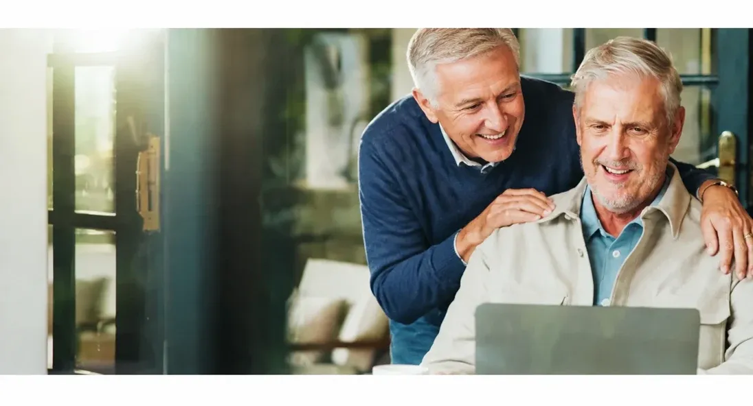 An older couple reviewing business information on a laptop